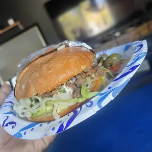 a hand holding a sandwich