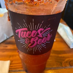a taco and beer on a table