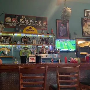 two men sitting at a bar