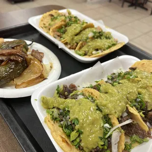 Chicken and steak tacos. Jalapeño and onions on the side