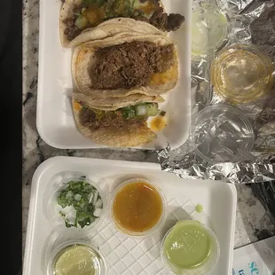 Carne and Birria tacos with condiments