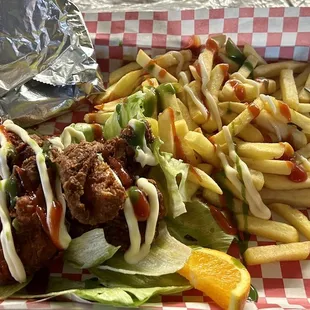 Pollo Frito con Papas (Fried Chicken w/ Fries) on lettuce and hand made tortillas! Hot sauce optional! Recommend it.