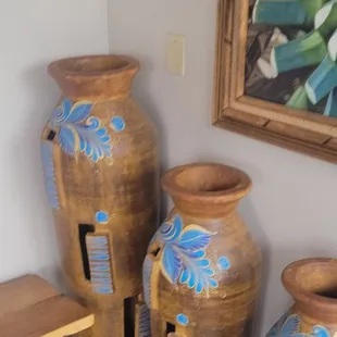 three vases with blue flowers on them