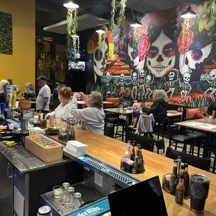 people sitting at tables in a mexican restaurant