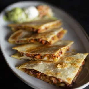 Savor our Gringa Quesadilla with flour tortilla, melted cheese, slow-roasted pork, and sweet pineapple for a perfect flavor combo!