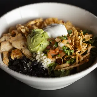 Cantina Bowl: A delicious bowl of rice, black beans, lettuce, pico de gallo, avocado, and crispy tortilla strips, topped with creamy queso.