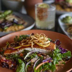 Salmon Salad: Perfect for lunch! Fresh greens, grilled salmon, avocado, queso fresco, and a zesty citrus dressing for a refreshing meal.