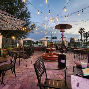 a patio with tables and chairs