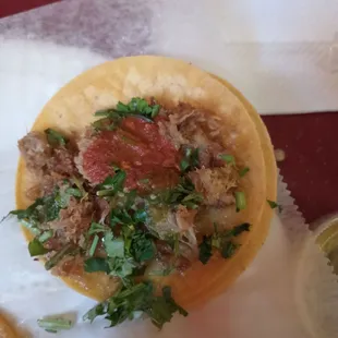 Carnitas tacos with red sauce.