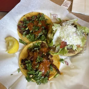 three tacoss on a table