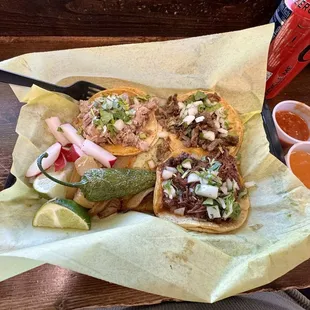 Carnitas, Asada and Barbacoa tacos. Watch out for that light orange salsa. Very hot.