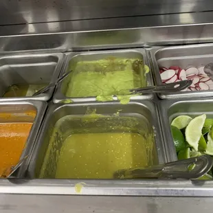 Hot and mild sauces; guacamole sauce; pickled jalapeños; fresh limes; radishes; chopped onions; pico de gallo; cilantro...