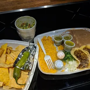 With an already quarter eaten fresh guacamole and lots of salsa verde!