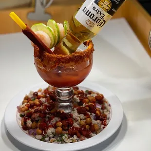 a bloody drink being poured into a glass