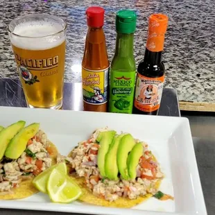 a plate of fish tacos and a beer