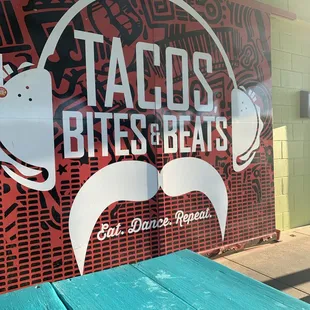 a sign for tacos bites and beats