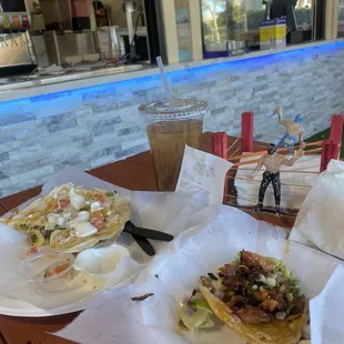L. Lengua quesadilla (7.99), top-tamarindo aqua (3.99) Front-al pastor tacos (3.49)