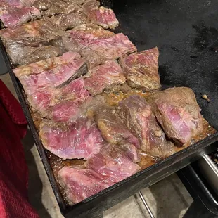 meat being cooked on a grill