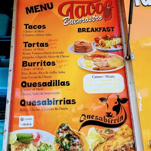 Menu next to pick-up window. Prices are handwritten and a little faded.