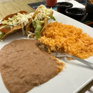 Hard shell chicken tacos plate with rice and beans