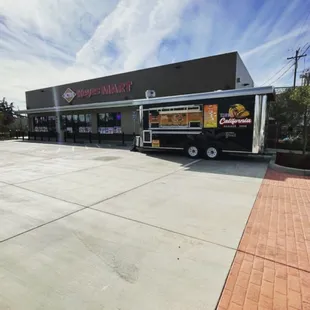 a taco truck parked in front of a restaurant