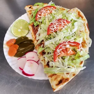 a plate of tacos and pickles