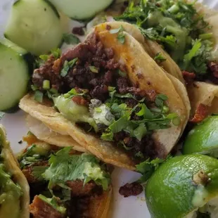 a plate of tacos and cucumbers