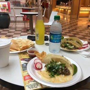 Tacos lengua, tacos al pastor, kids quesadilla, and pineapple soda.