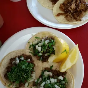 Asada tacos w/onions and cilantro (street tortillas), and carnival tacos (in flour tortillos)
