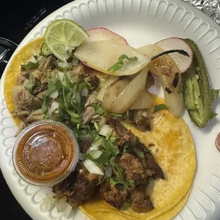 a person holding a plate of food