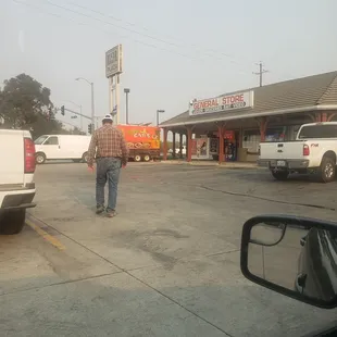 a man walking in a parking lot