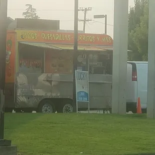 a taco truck parked on the side of the road