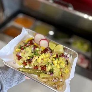 a person holding a tray of food