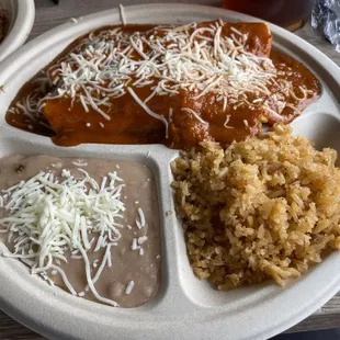 Enchilada plate with tasty refried beans and rice.