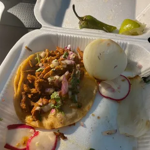Al pastor. No pineapple given. Raw onion. No salsa