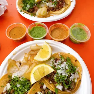 two plates of tacos on a table