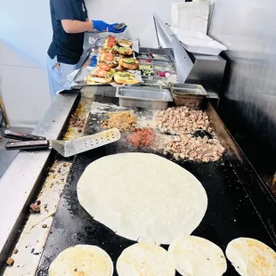 a woman making tortillas