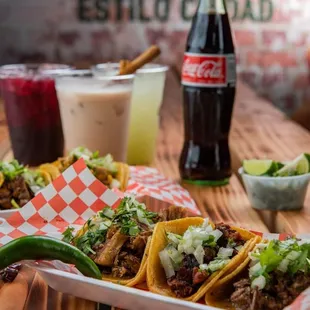 a plate of tacos and a coke