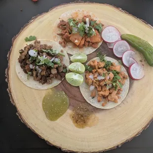 3 meat tacos: carne asada, chicken and al pastor. With fresh green and red salsa.