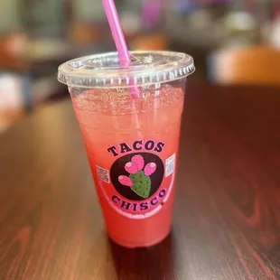 a pink drink with a straw