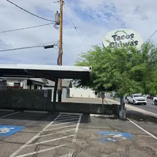 Signage and partially covered parking lot