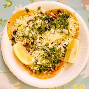 a plate of food with a lemon wedge