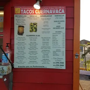 a menu on a red building