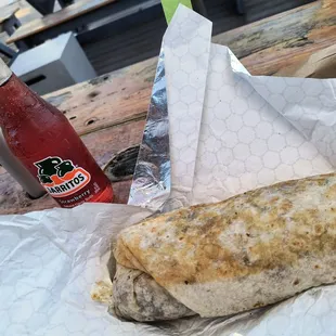 Barbacoa Cachete Burrito and a strawberry Jarritos drink.