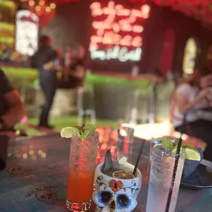 a table with drinks and a sugar skull