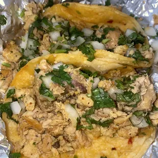 2 chicken tacos. PACKED with meat and so flavorful. I suggest the green salsa and some guac on top! The guac adds a nice kick of spice