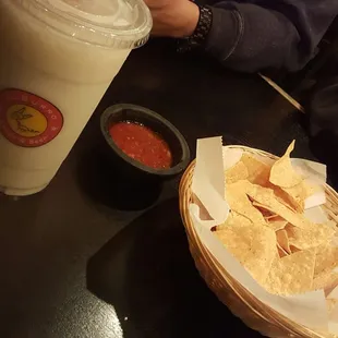 a basket of chips and a drink