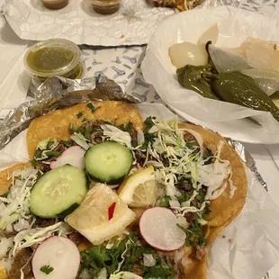 Asada burrito and tacos with grilled onions and jalapeños on the side (no extra charge)