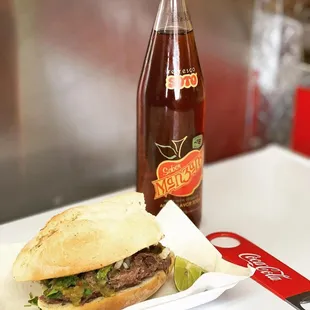 a sandwich and a bottle of soda
