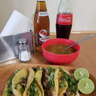 a bowl of salsa and a bottle of coke